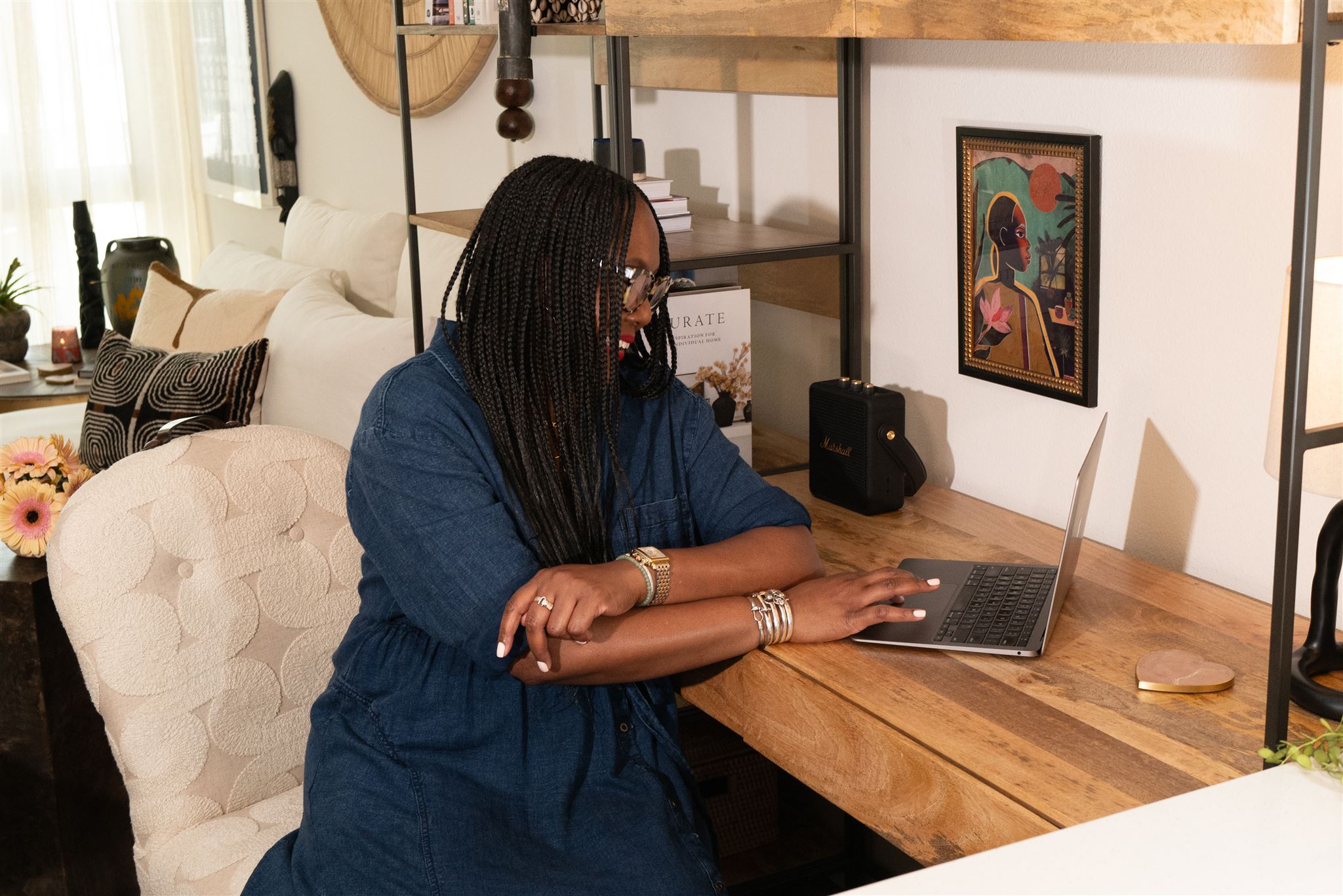 Jen Du Bois, Certified Wellness & Home Coach, smiling at her desk during a virtual organizing session, showing how online home coaching can support real-life change.